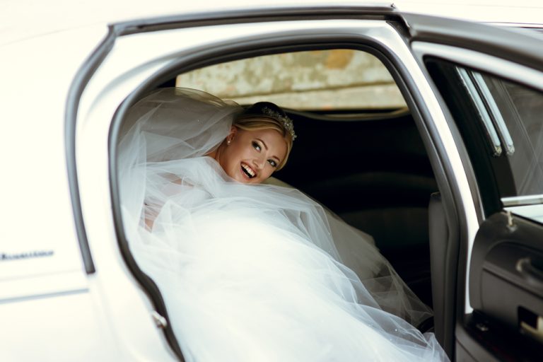 Beautiful,Blonde,Bride,In,The,Car,On,The,Wedding,Day