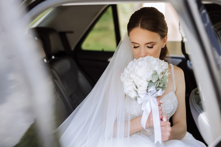 The,Bride,Is,Sitting,In,A,Black,Car,With,A