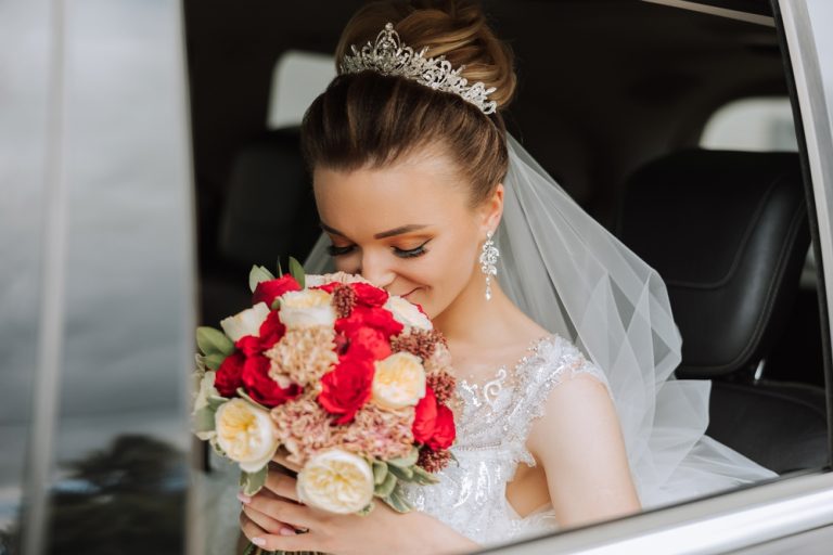 The,Bride,Is,Sitting,In,A,Black,Car,With,A