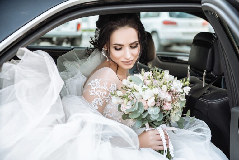Dark-haired,Bride,Jewelry,Head,Sits,In,A,Black,Car,On